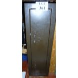 A metal shotgun cabinet with two locks a