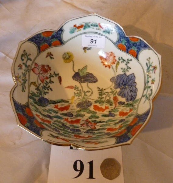 A lotus flower shaped bowl decorated wit