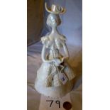 A lustre pottery figurine of a woman rea