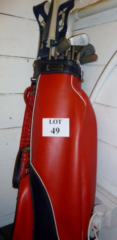 A set of golf clubs in bag; and a set of