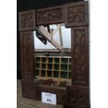 A decorative carved oak mirror est: £30-