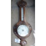 An oak framed barometer (dial cracked) w