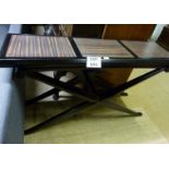 A designer console table with black X fr