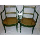 A pair of French green panelled chairs w