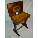 A Victorian walnut inlaid work table wit