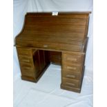 A c1900 oak 'S' type roll top desk with