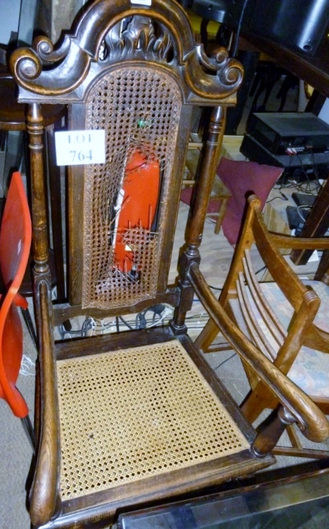 A 17c style oak elbow chair with cane se