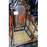 A 17c style oak elbow chair with cane se