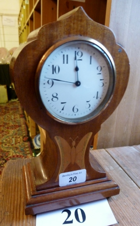 An Edwardian mahogany balloon clock with