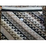 A hand knotted woolen rug with vibrant c