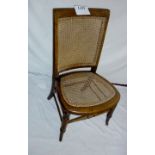 A Victorian cane chair with splayed legs