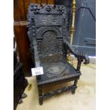 A 19c carved oak throne chair with figur