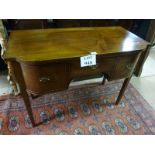 A c1900 mahogany bow fronted table with a central frieze drawer flanked either side by cupboards (