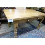 An early 20c pine kitchen table with sol