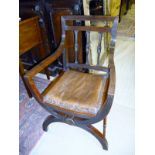 A mahogany X frame chair with studded le