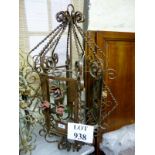 A decorative painted metal garden lanter