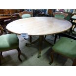 An oval 19c pine kitchen table on carved
