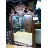 A late 20c mahogany carved wall mirror i