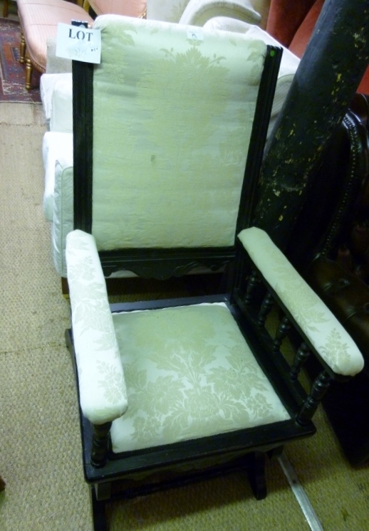 An Edwardian ebonised rocking chair upho