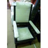 An Edwardian ebonised rocking chair upho