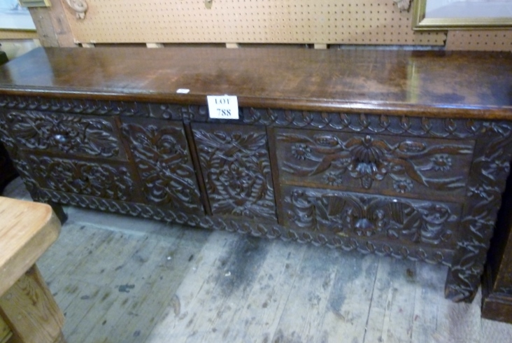 A 19c carved oak sideboard with carved d