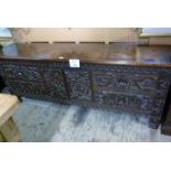 A 19c carved oak sideboard with carved d