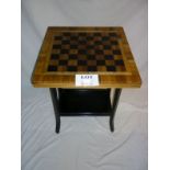 An early 20c chess table on ebonised bas