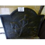 A large cast iron fire back with hunter