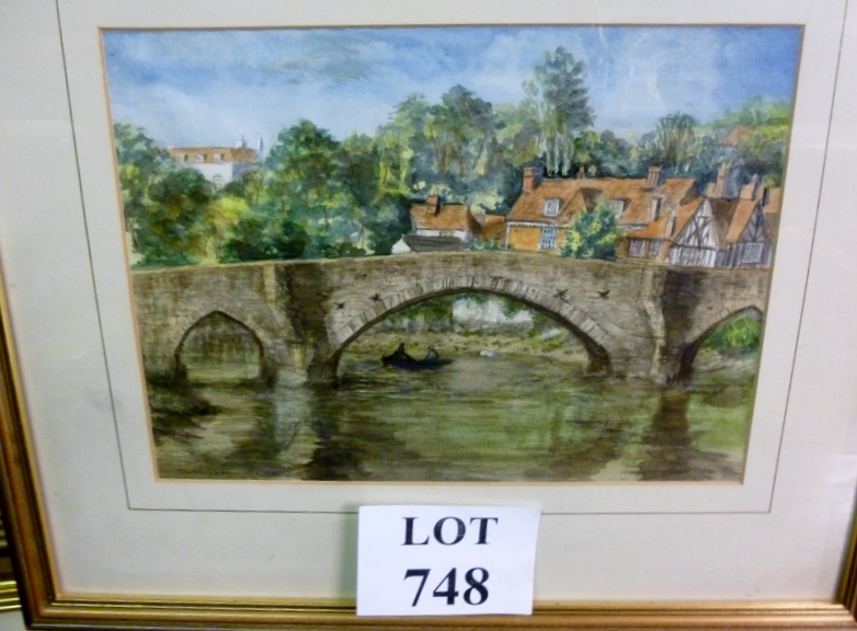 A framed and glazed watercolour study of a bridge over a canal with rowing boat and surrounding