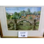 A framed and glazed watercolour study of a bridge over a canal with rowing boat and surrounding