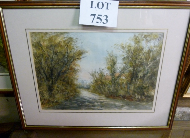 A framed and glazed watercolour depicting a woodland path signed T W Maybourne lower right est: