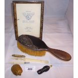 A metal vesta case in the shape of a turtle, an ivory paper knife, an ebony whistle, photo frame,