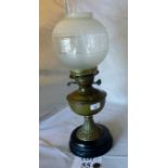 A brass oil lamp with frosted glass globe est: £25-£45 (G1)