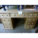 A pine pedestal writing desk with nine drawers est: £100-£200