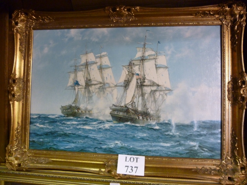 A gilt framed Montague Dawson print of two battle ships at sea bears printed signature est: £40-£60