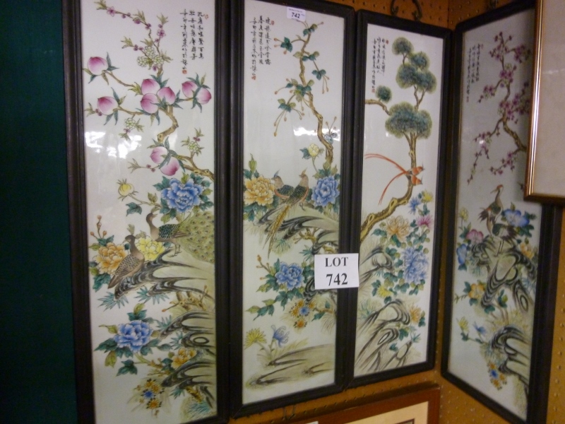 A set of four Chinese paintings on porcelain depicting scenes of birds amongst foliage all signed