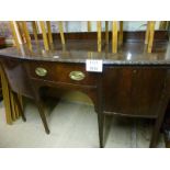 An early 20c mahogany bow front sideboard with central drawer flanked either side by cupboards est: