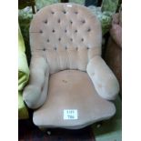 A Victorian deep buttoned armchair with turned legs and white china casters est: £50-£100