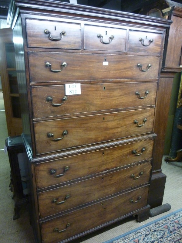 A George III mahogany chest on chest with three small drawers over six long all with brass swan