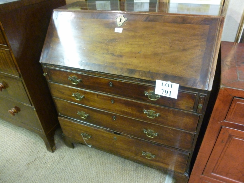 A Georgian mahogany writing bureau with a fitted interior over four long drawers est: £200-£400