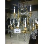 A large 12 branch brass chandelier complete with crystal drops est: £250-£400