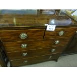 A George III mahogany chest of two short over three long drawers (in two sections) with brass oval