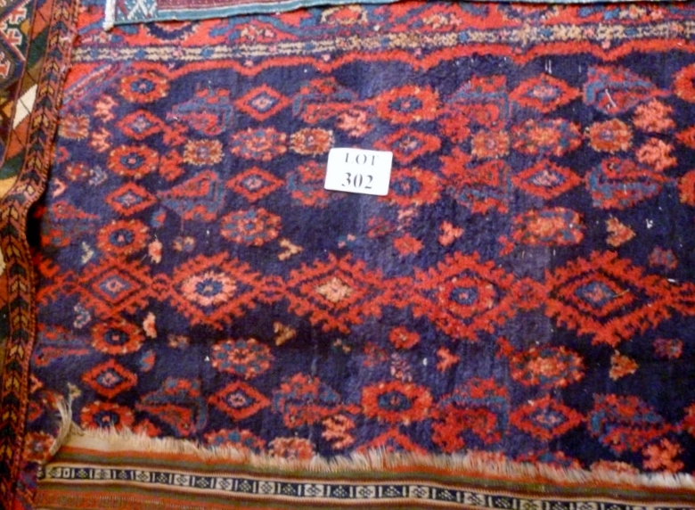 An early mid 20c Persian rug on blue field (220 x 130 cm approx) est: £70-£90