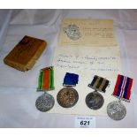 A collection of four medals to include two WWII (War & Defence) medals and a piece of the Berlin