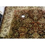 A large wool carpet on brown ground (350 x 245 cm approx) est: £200-£300