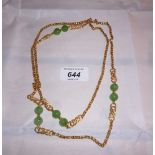 An 18ct gold necklace with seven possibly jade beads (approx 40" long) est: £900-£1,