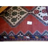 An early mid 20c Persian rug on rose field (290 x 130 cm approx) est: £80-£120