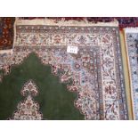 A Komya Ladik carpet on green ground (168 x 266 cm approx) est: £150-£250