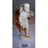 An oriental ivory carving of a man carrying his work tools signed est: ££100-£130