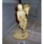 An oriental ivory carving of a fisherman with his basket of fish est: £150-£200